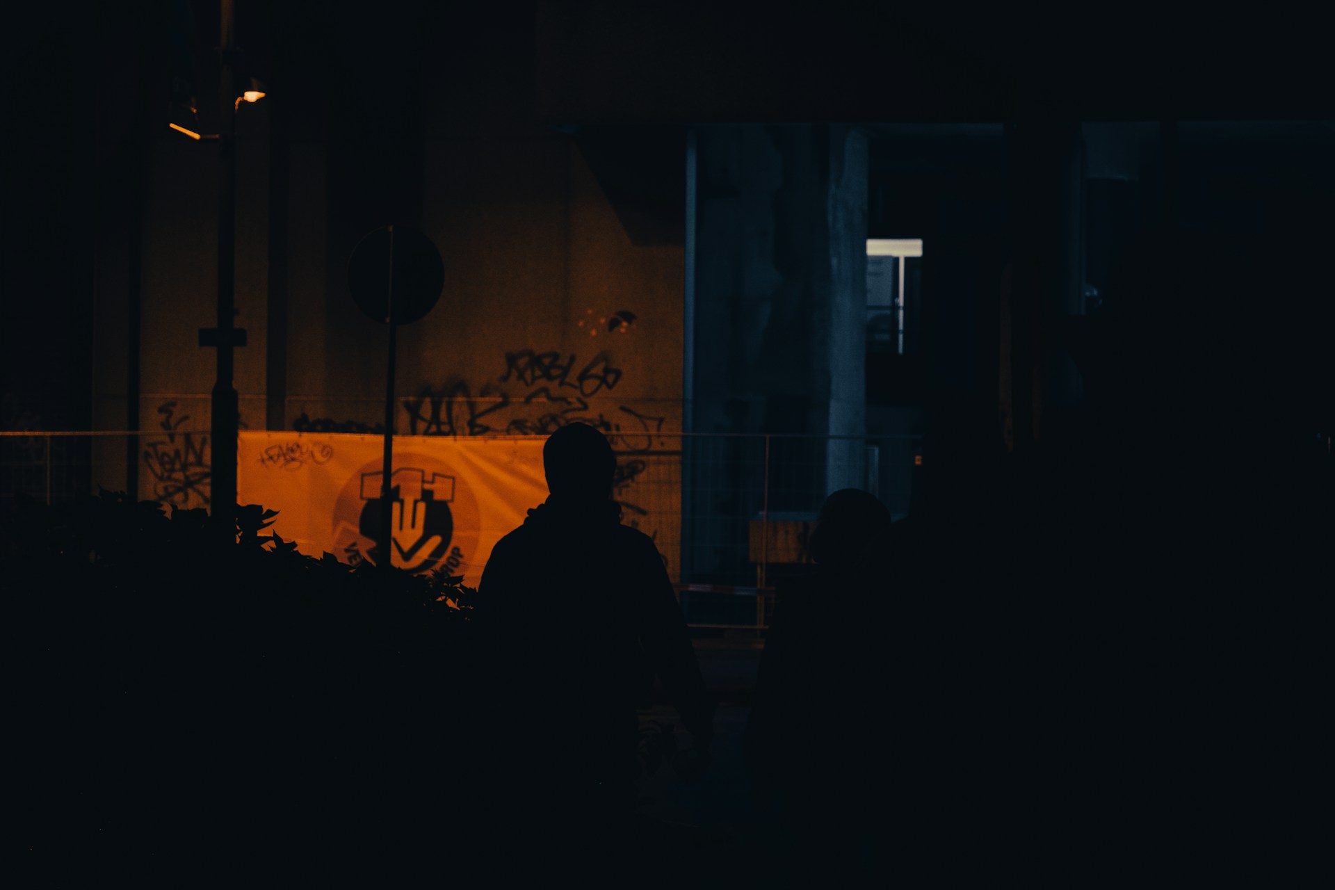 a group of people standing in front of a building with graffiti on it