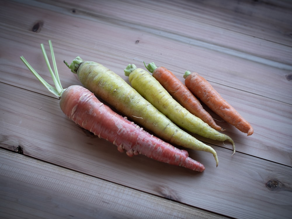 a group of carrots on a wooden surface
