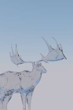 A majestic deer sculpture made entirely of translucent ice, displaying intricate details and smooth, flowing lines. The background is a gradient of light blue and white, suggesting a calm and cold atmosphere.