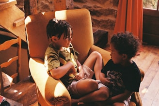 A child and therapist sitting together in a bright, welcoming therapy room.