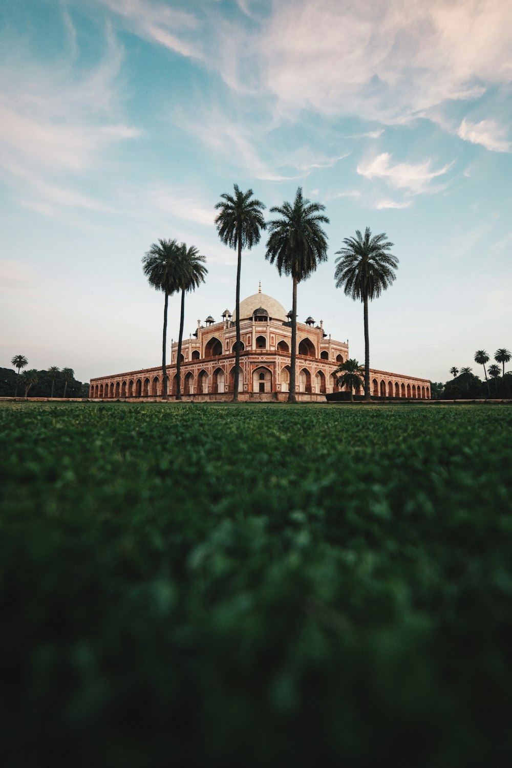 a large building with palm trees in front of it