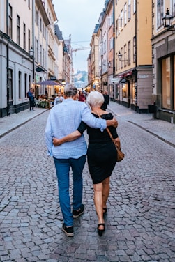 a man and woman kissing on a street