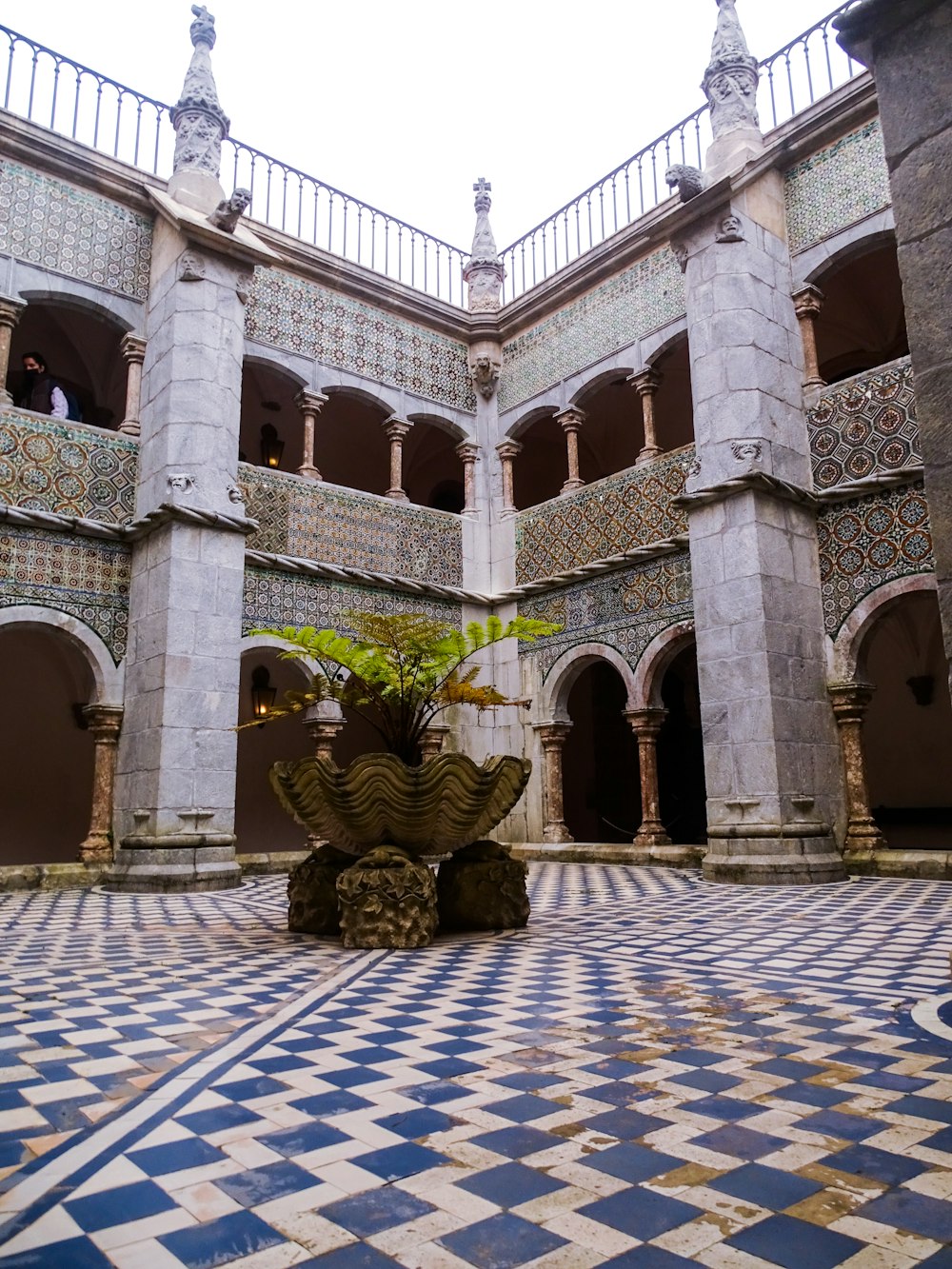 a courtyard with a building in the background
