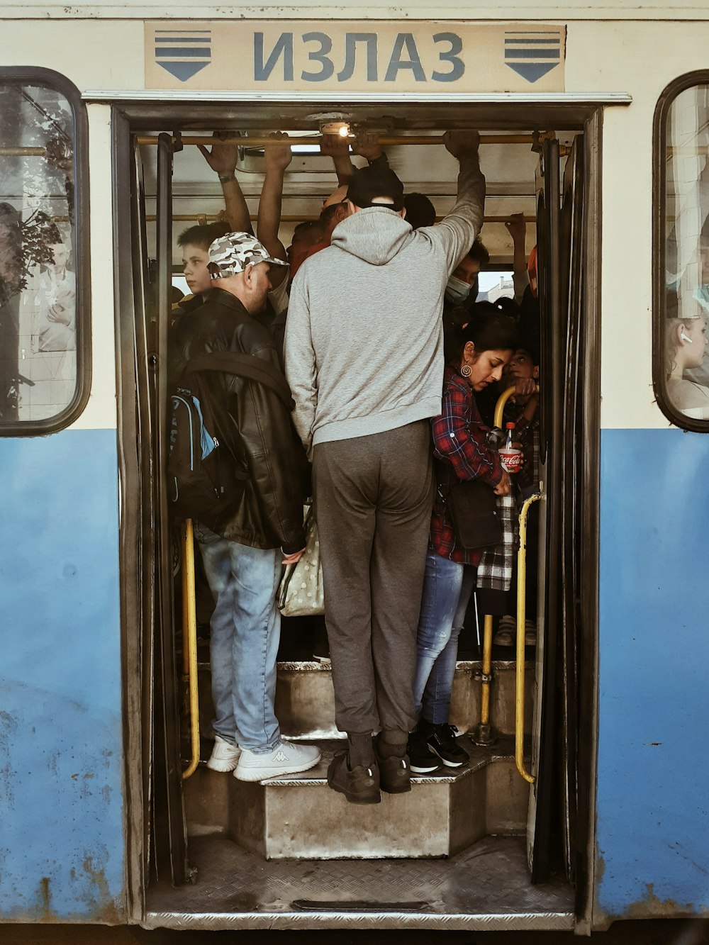 a group of people standing in a train