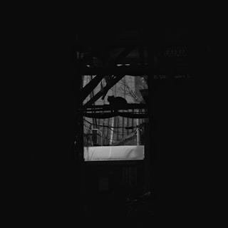 a black and white photo of a building with a large window