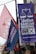 Colorful political banners and flags are displayed in an outdoor setting, featuring campaign slogans and symbols.