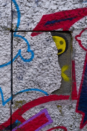 Close-up of a Concrete Soul cap with graffiti art in the background.