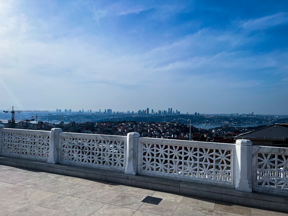 a white fence with a city in the background