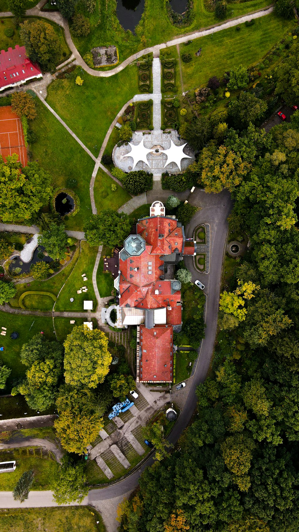 a large building with a tower in the middle of a park