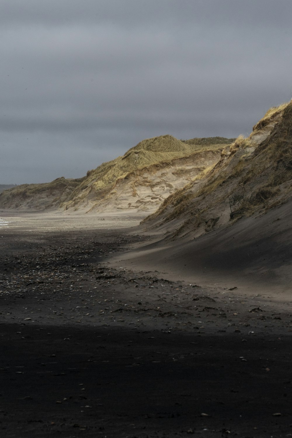 a sandy beach with hills