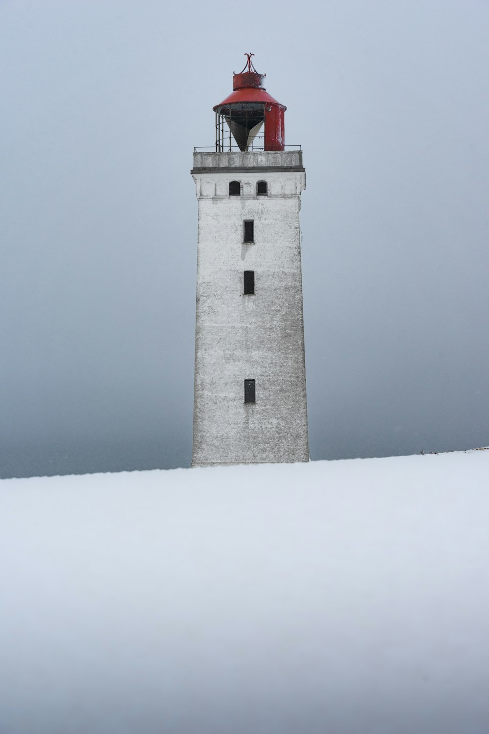 a lighthouse in the snow