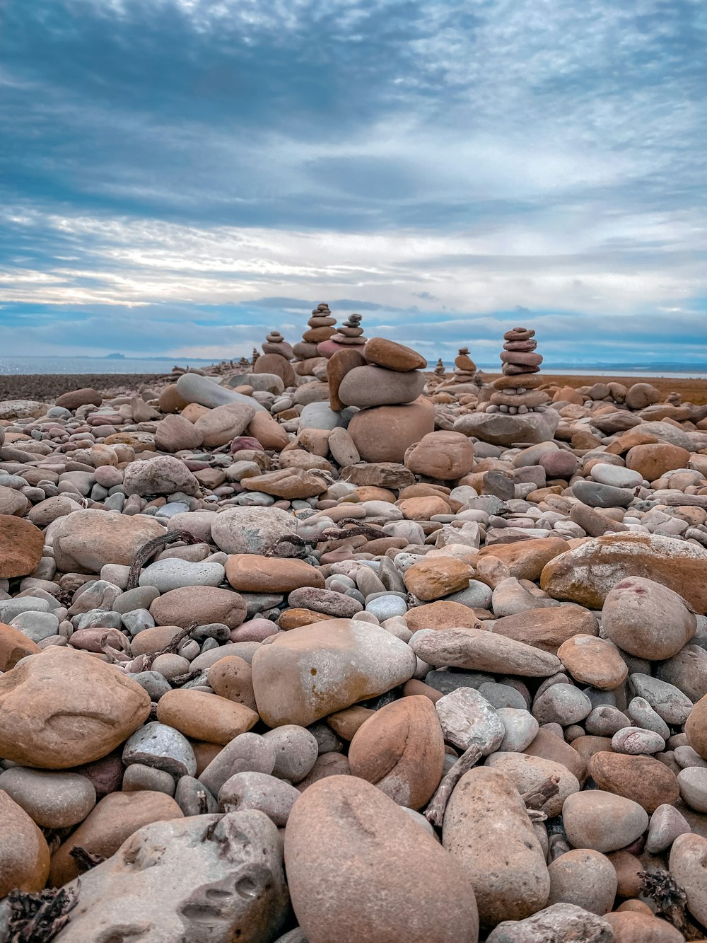 a rocky beach with a few people on it