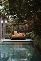 a pool with a lounge chair and a sign above it