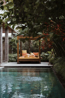 a pool with a lounge chair and a sign above it