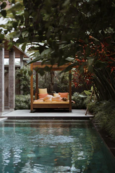 a pool with a lounge chair and a sign above it