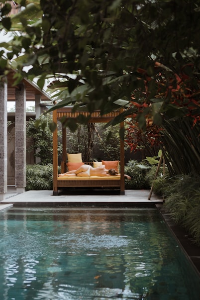 a pool with a lounge chair and a sign above it