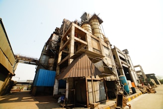 Industrial plant with large process equipment under clear sky.