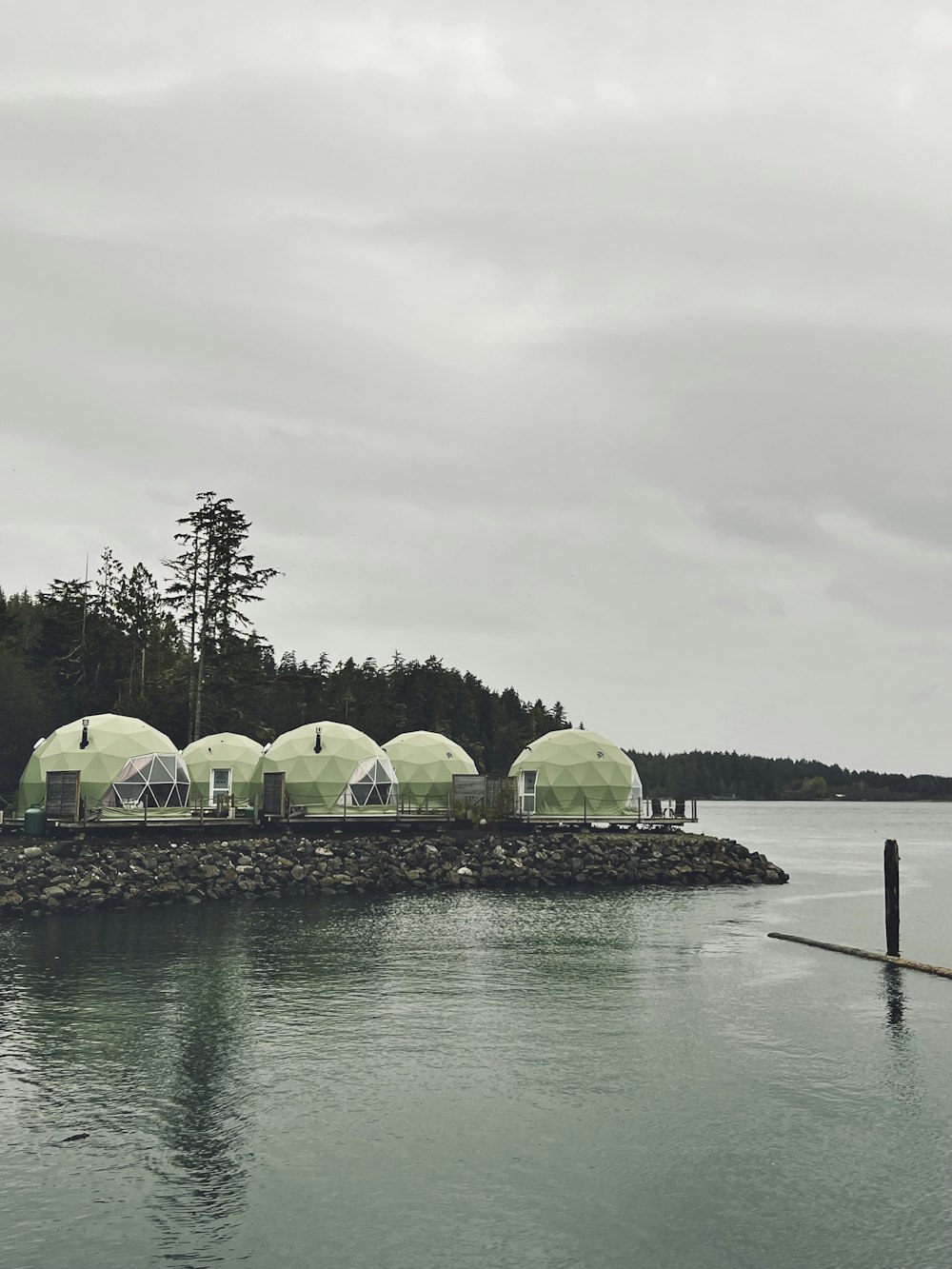 a group of tents sitting on top of a body of water