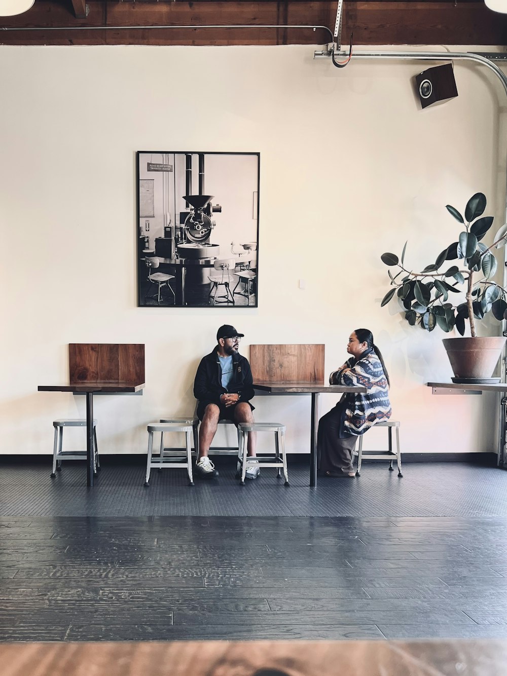 two people sitting at a table in a room