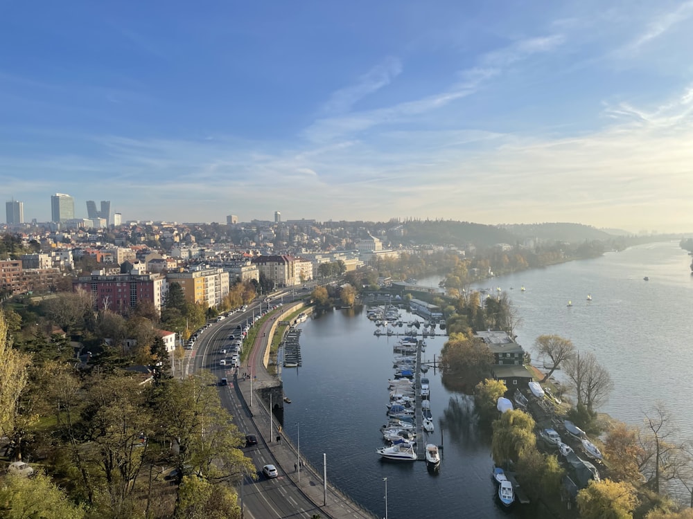 a river with boats on it and a city in the background