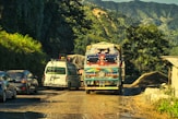 a group of vehicles travel down a road