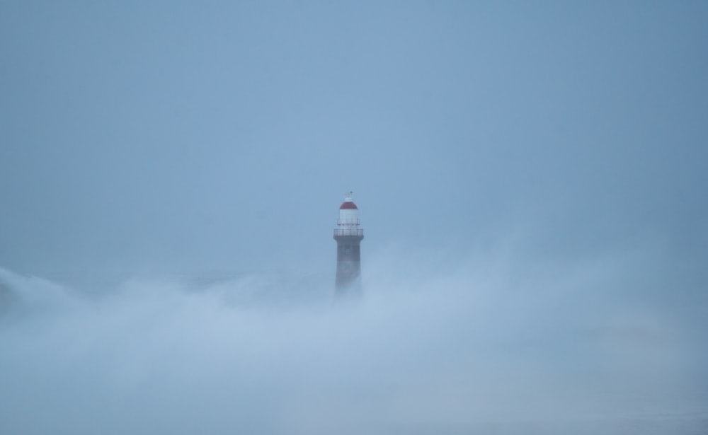 a lighthouse in the middle of a cloudy sky
