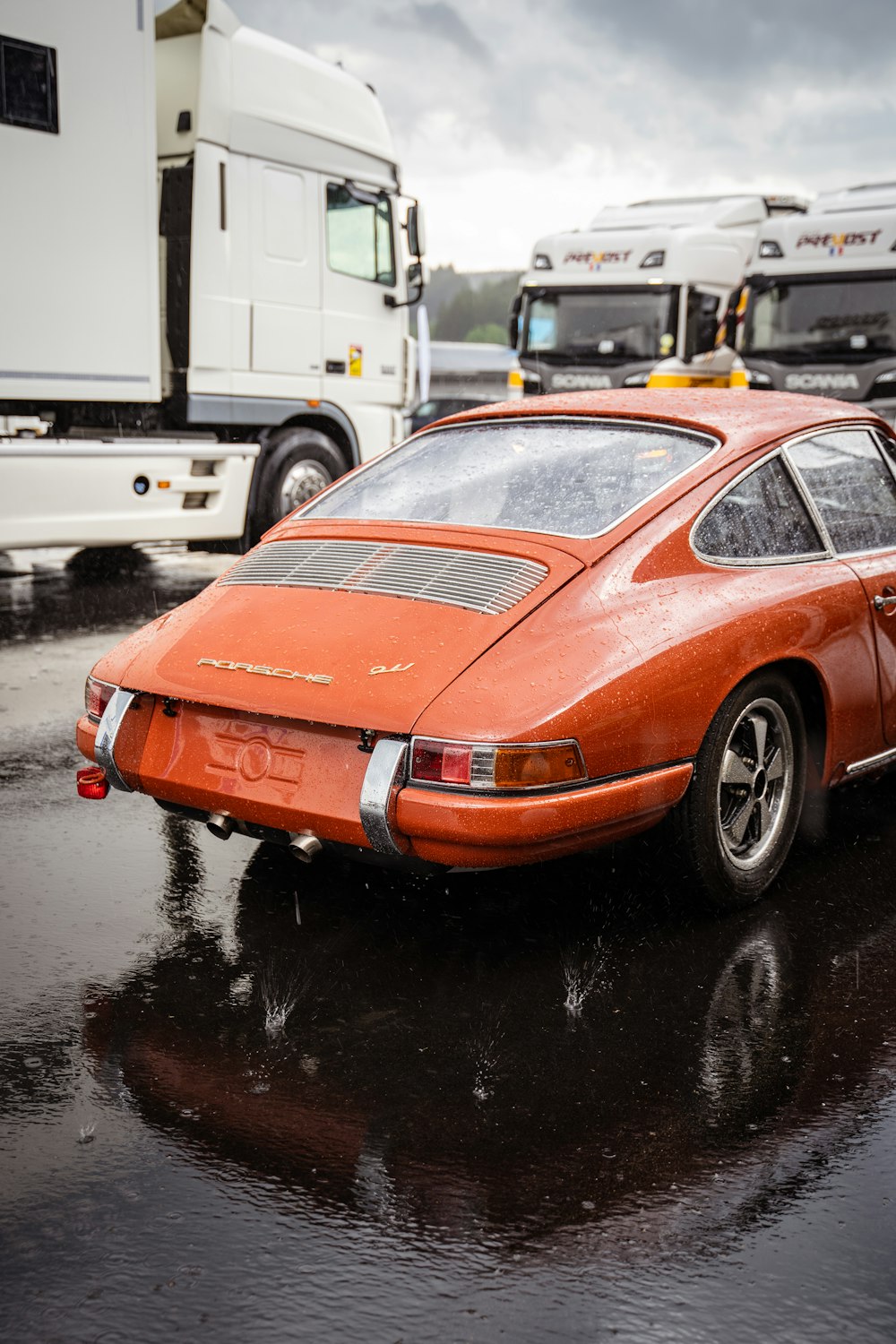 an orange car parked in a parking lot