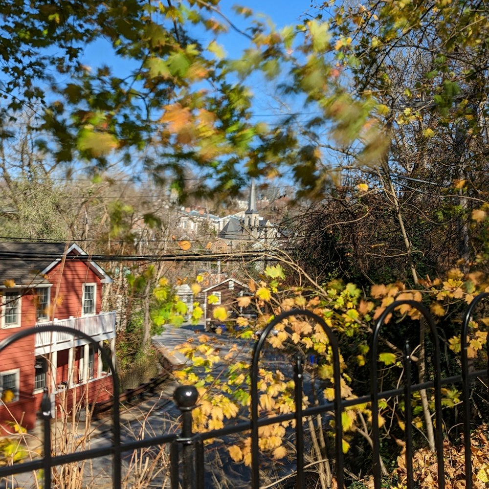 a fence with a view of a town and trees