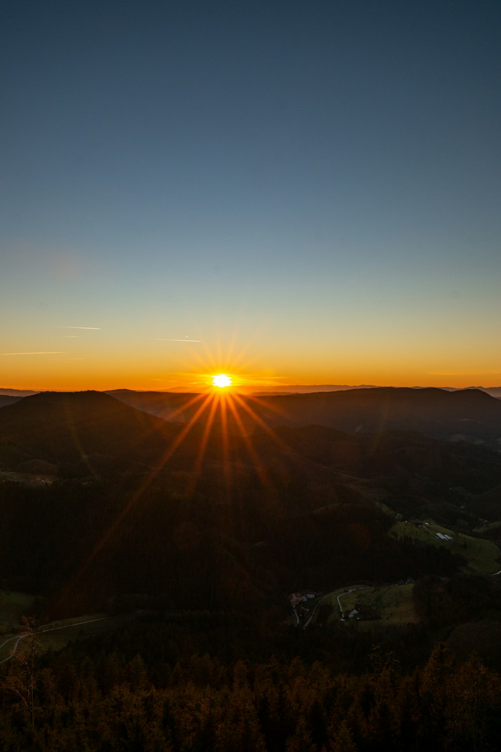 a sunset over a valley