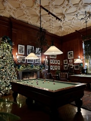 Interior of a clubhouse lounge with comfortable seating and golf memorabilia.