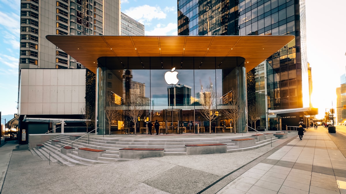 Apple Store storefront illuminated at night with the Apple logo prominently displayed