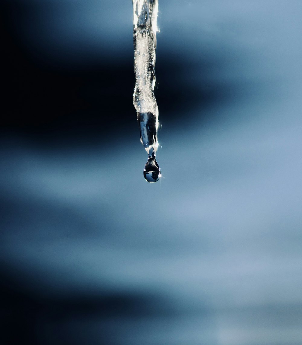 a close-up of water dripping from a tap