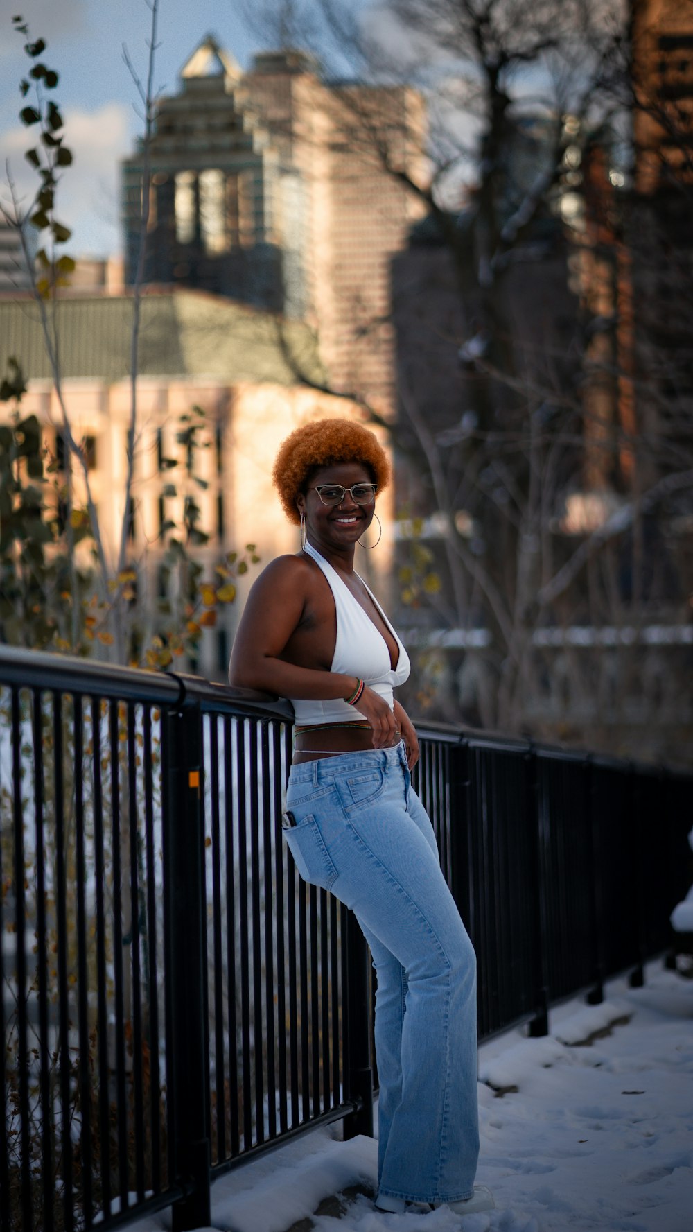 a woman leaning on a fence