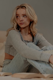 a woman sitting on a bed