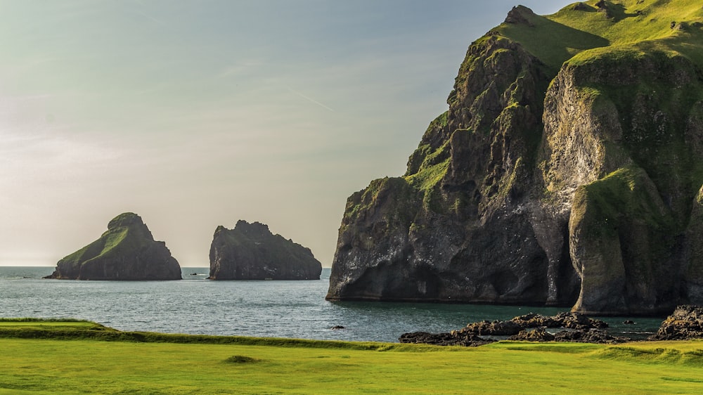 a group of large rocks by the water