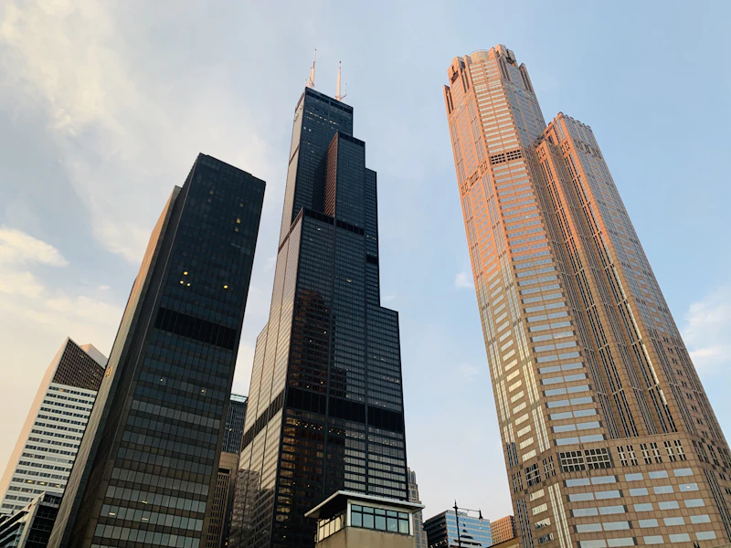 The Willis Tower rising above the Chicago skyline, seen from street level