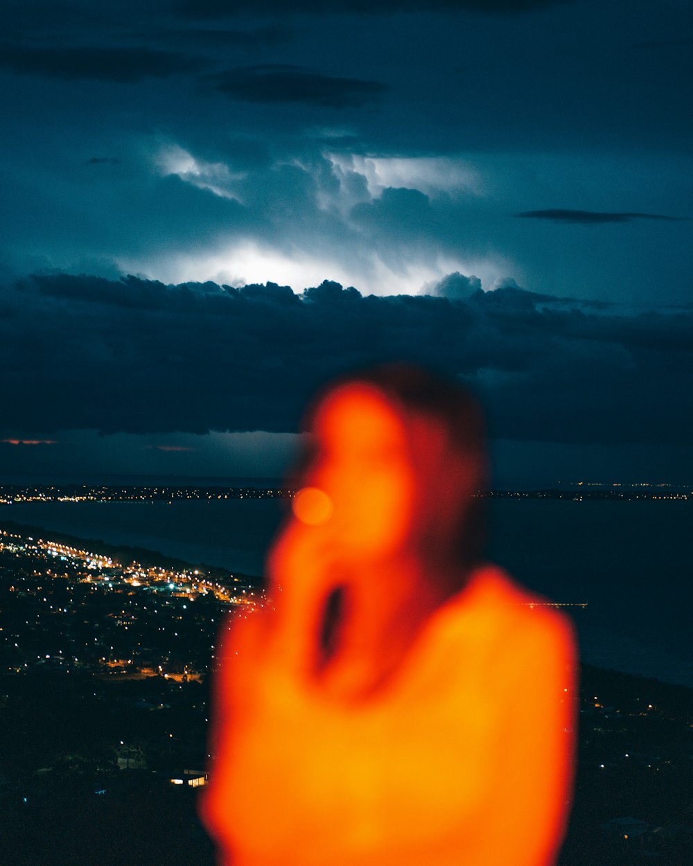 a hand with a city in the background