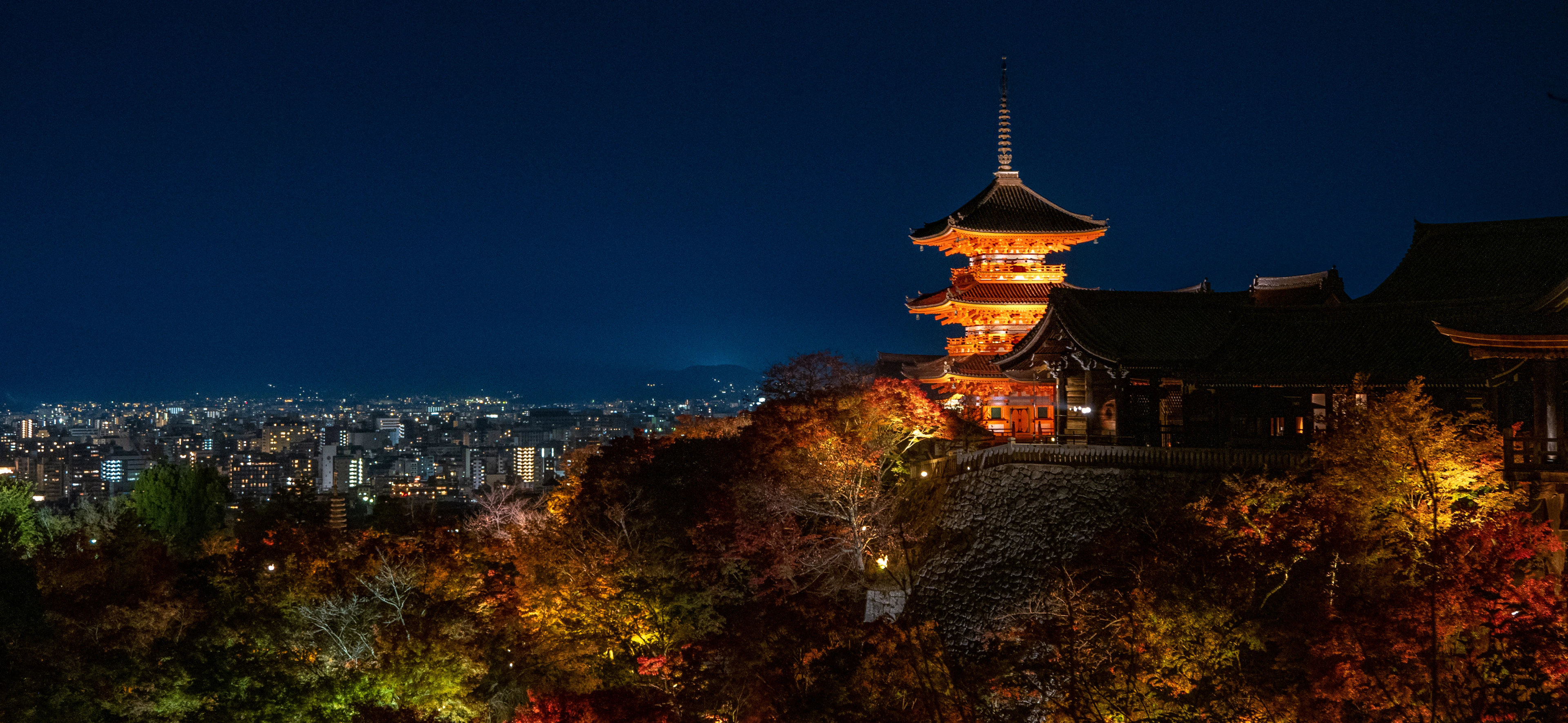 Kiyomizu-dera's pagoda lit up above Kyoto at night