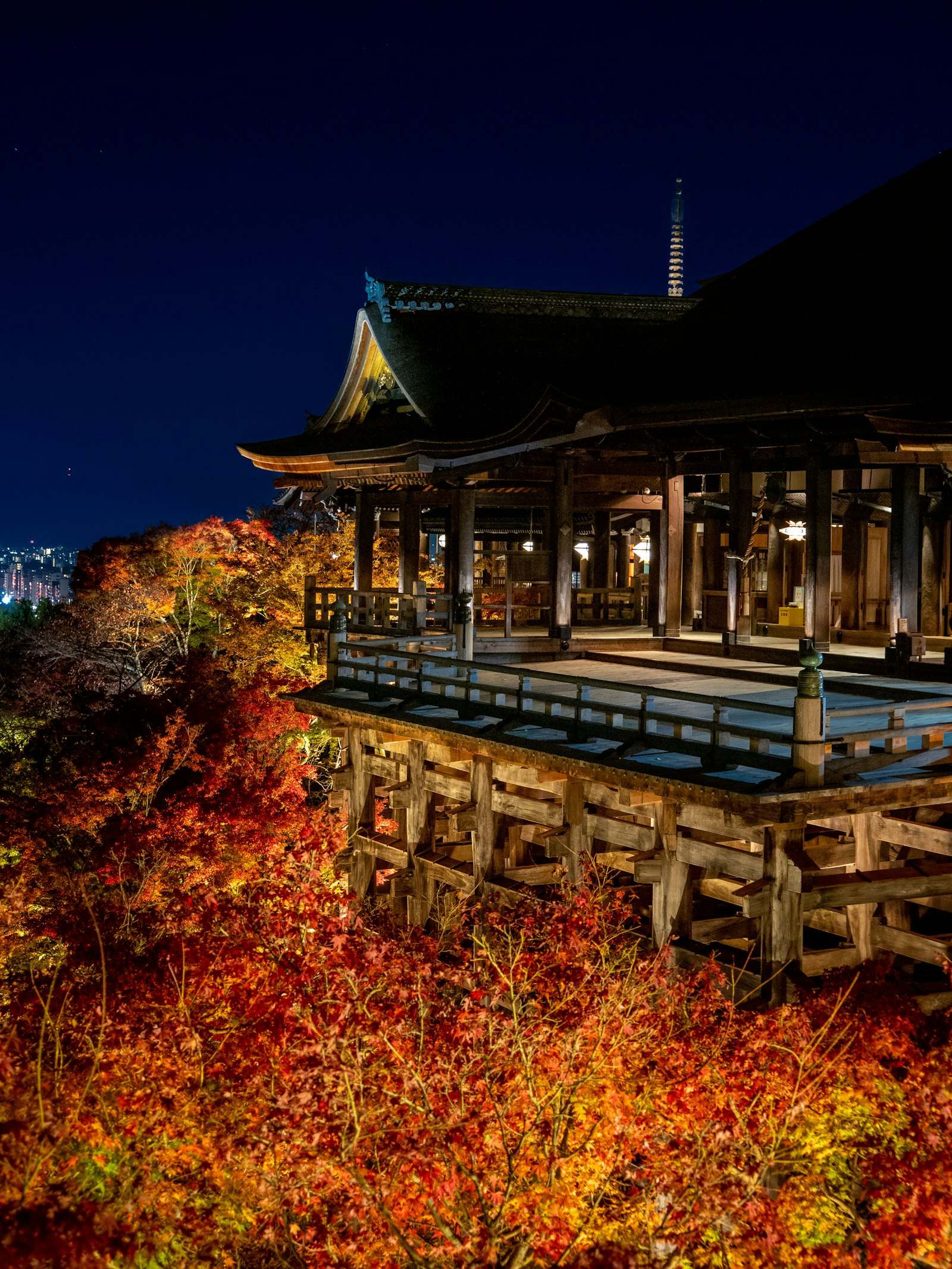 Kiyomizu-dera temple surrounded by trees, with a pond in the foreground, Kyoto