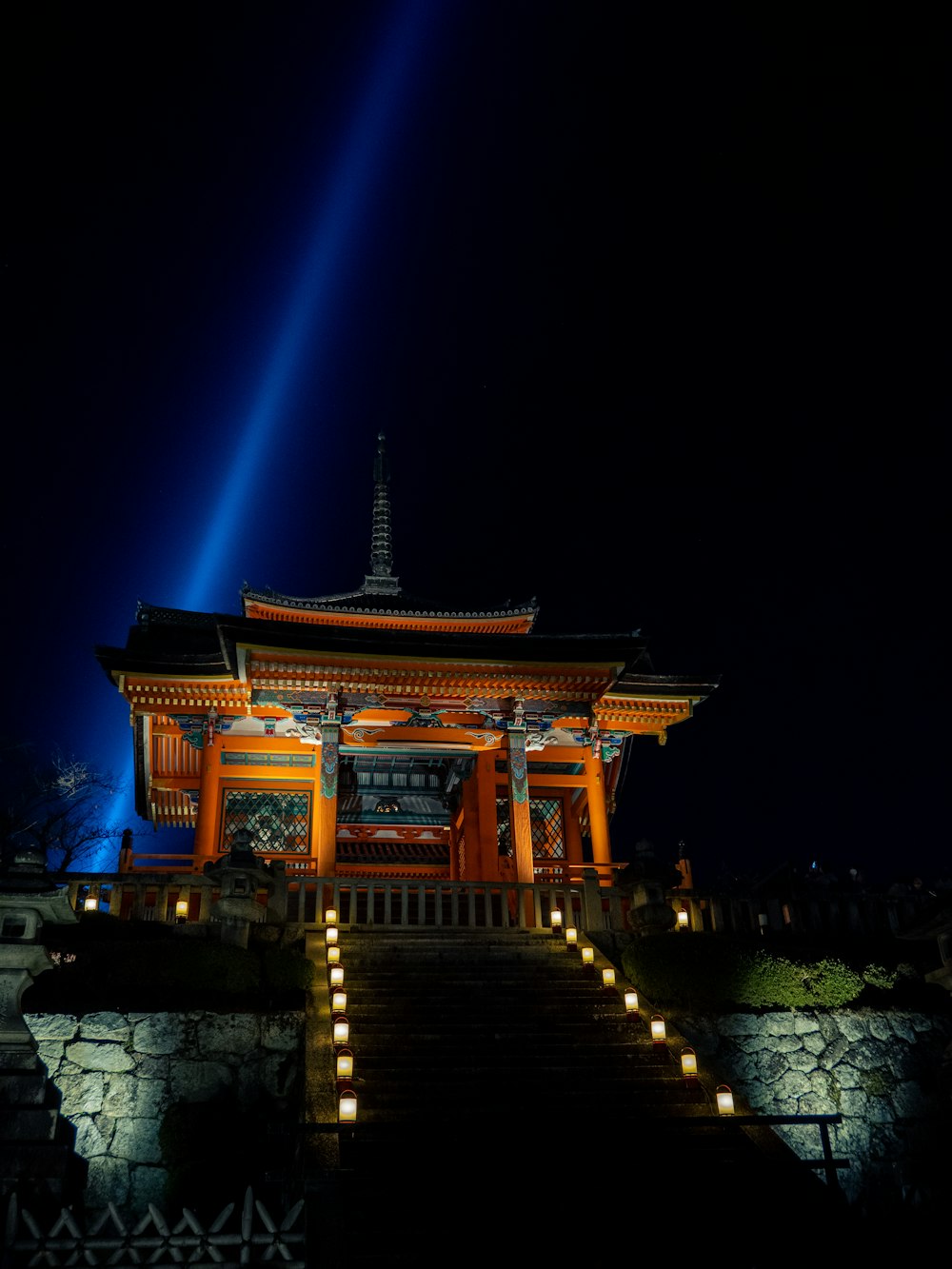 a building with a tower and a lit up staircase at night