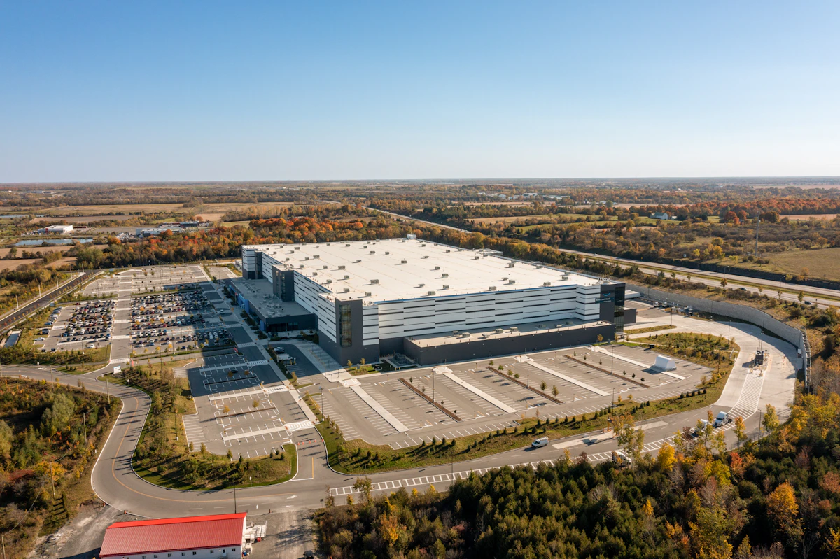 Large modern industrial facility with an adjacent parking and staging lot