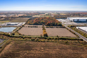 a large field with many buildings in the background