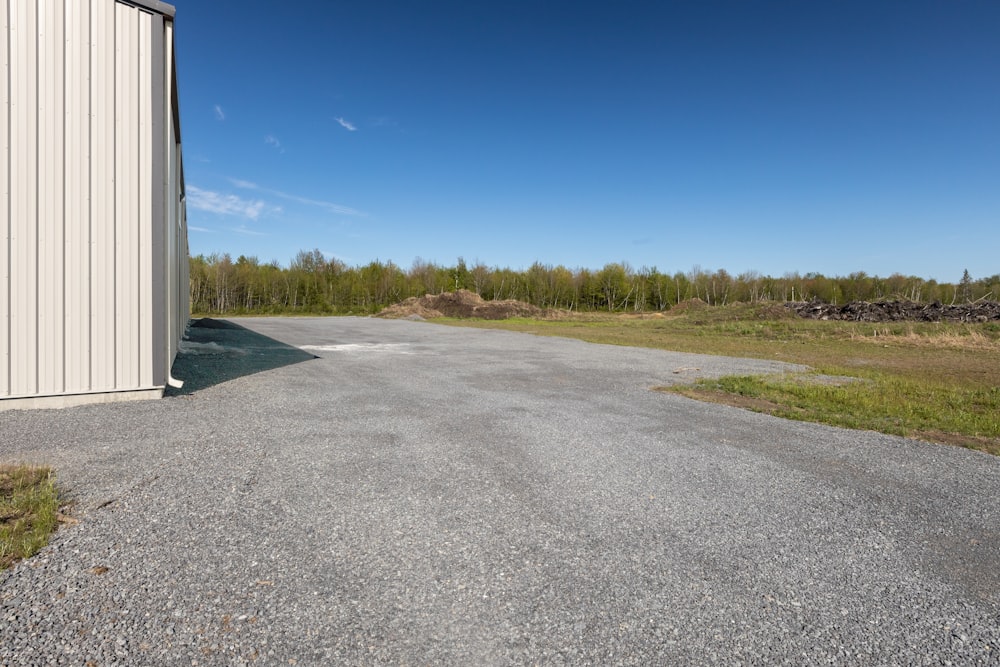 a road with grass and trees on the side