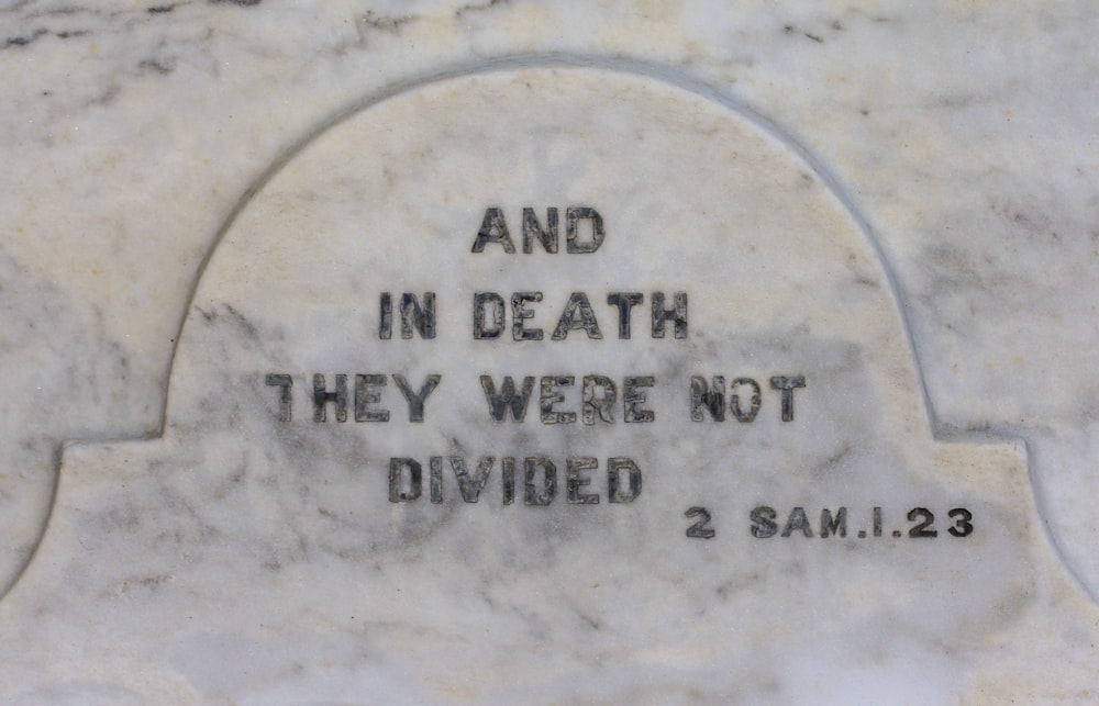 a close up of a memorial with a quote on it