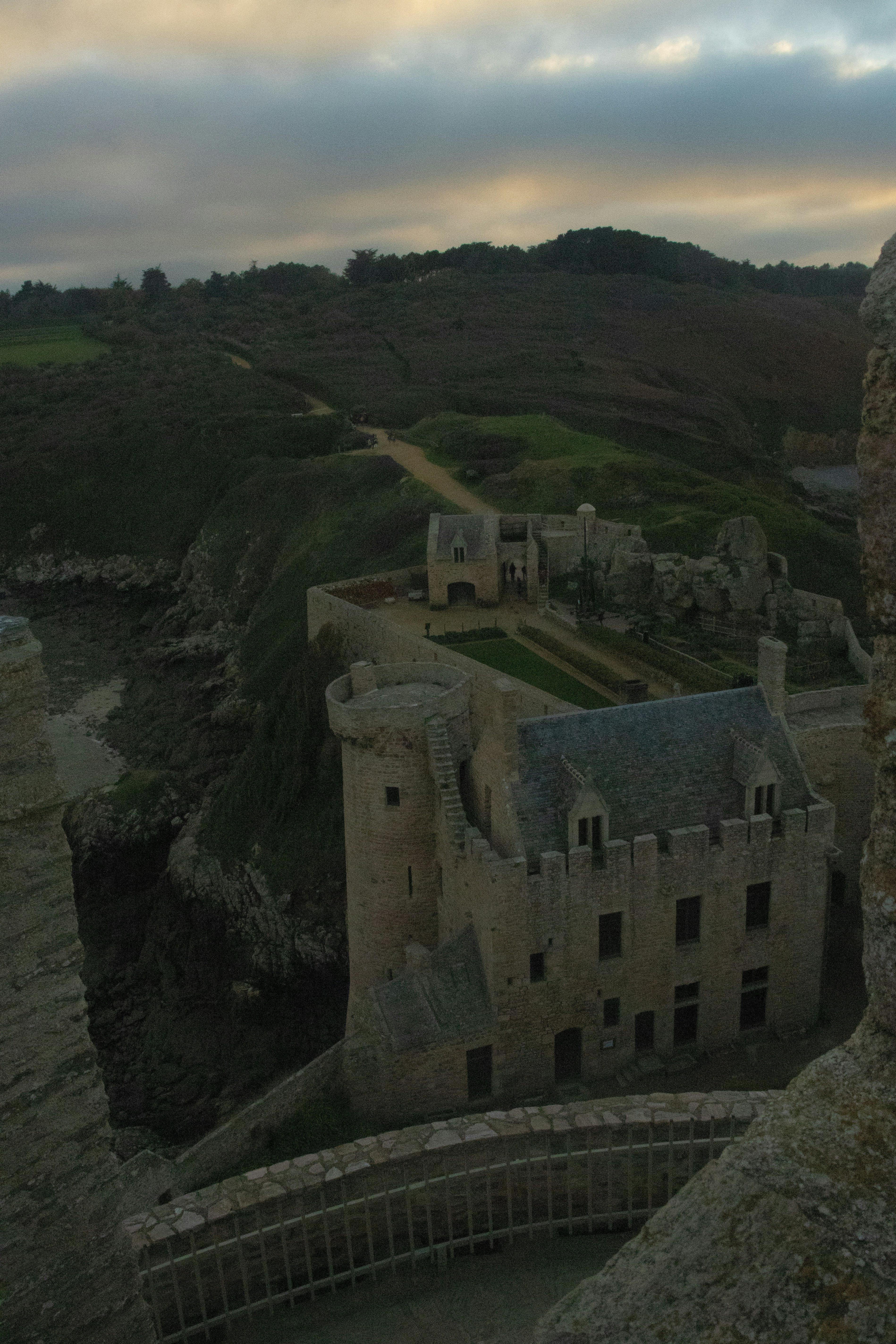 a stone building on a cliff