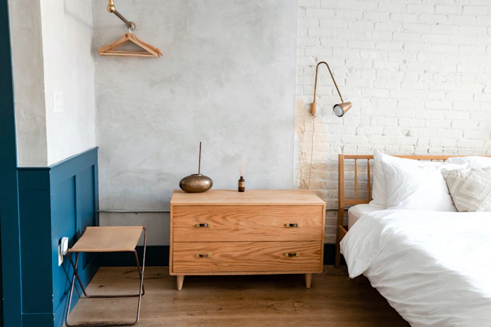 A calm bedroom with neutral colours and a bedside table