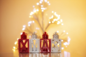 A close-up of glowing light letters in a festive setting.