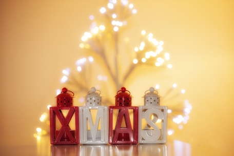 A close-up of glowing light letters in a festive setting.