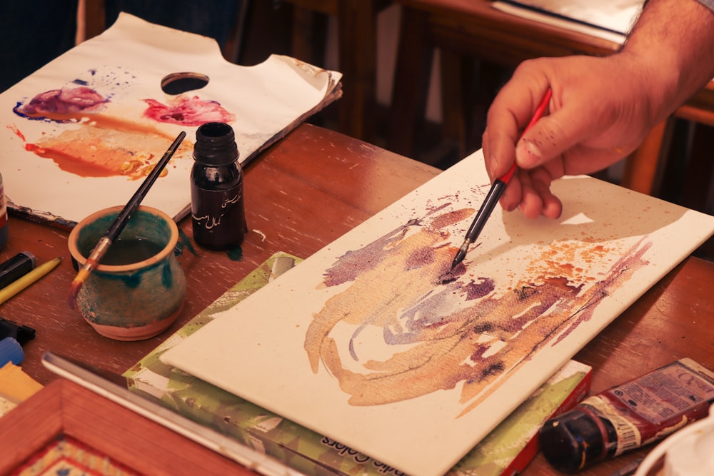 a person painting on a table