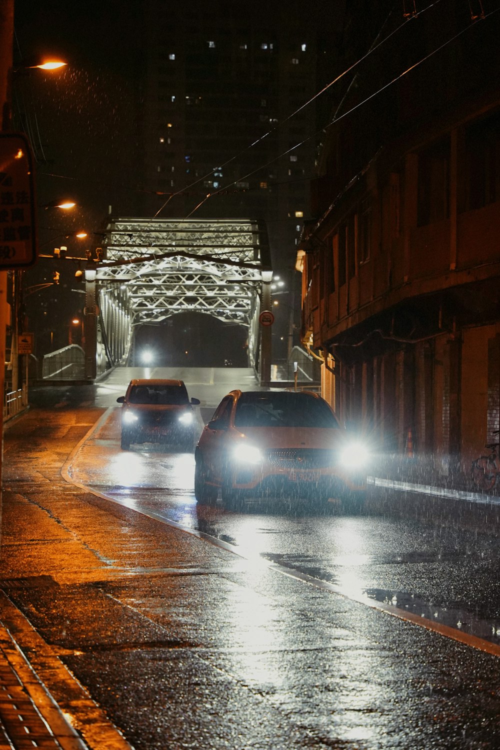 cars driving under a bridge